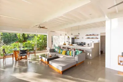 a living room with a couch and a table at Casa AtrapasueñosEpic View Surfer's Paradise in Santa Teresa Beach