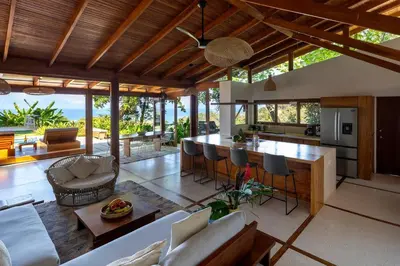 an open kitchen and living room with a view of the ocean at Casa RicaSunset ocean view pool fiber optic in Cóbano