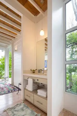a bathroom with a sink and a mirror at Casazul - Tropical escape ocean views in Santa Teresa Beach