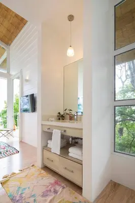 a bathroom with a sink and a mirror at Casazul - Tropical escape ocean views in Santa Teresa Beach