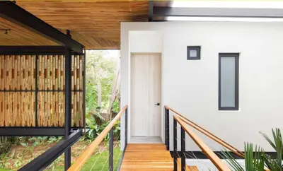 a hallway of a house with a wooden stairway at Naia Surf VillasWalk to Beach 2 Private Pools in Santa Teresa Beach