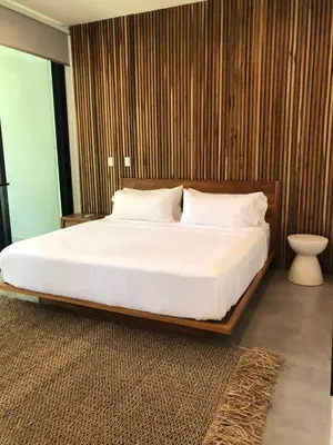 a bedroom with a large bed with white sheets and pillows at Naia Surf VillasWalk to Beach 2 Private Pools in Santa Teresa Beach