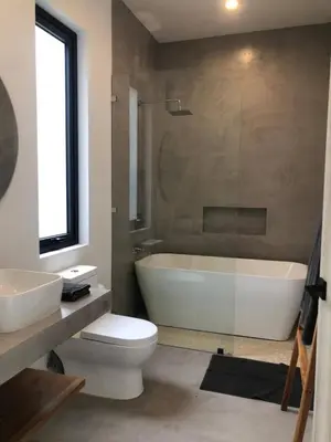 a bathroom with a tub and a toilet and a sink at Naia Surf VillasWalk to Beach 2 Private Pools in Santa Teresa Beach