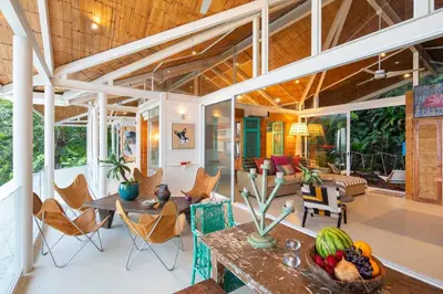 a living room with a table and chairs at Nido del Mar - Art-Filled Beach house in Santa Teresa