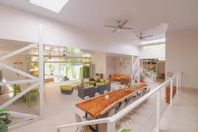 a large living room with a table and a couch at Luxury Beachfront VillaBest Surf Spot in Santa Teresa Beach