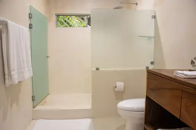 a bathroom with a shower and a toilet at Luxury Beachfront VillaBest Surf Spot in Santa Teresa Beach