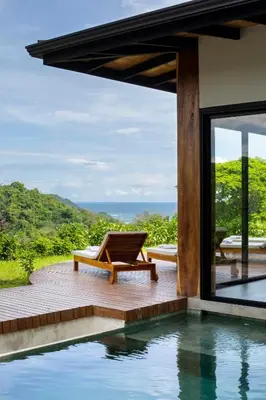 a villa with a swimming pool and a view of the ocean at Villa Ayla - Santa Teresa Minutes from the beach in Carmen