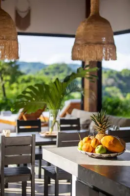 a bowl of fruit on a table in a restaurant at Villa Ayla - Santa Teresa Minutes from the beach in Carmen