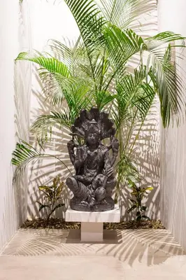 a statue of a deity with two plants at Villa Ayla - Santa Teresa Minutes from the beach in Carmen