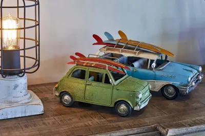 two toy cars with surfboards on top of a table at Casa Colibri - Stunning ocean view in Santa Teresa Beach
