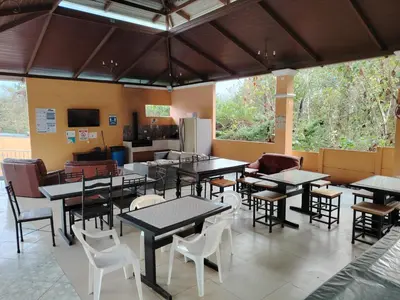 a restaurant with tables and chairs in a room at SJO airport eco-Escape, Villa jr 2 & Pool in Tivives