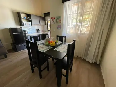 a dining room table with a bowl of fruit on it at SJO airport eco-Escape, Villa jr 2 & Pool in Tivives