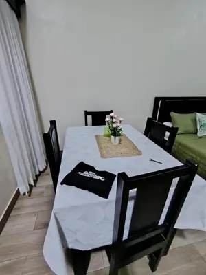 a dining room table with a white table cloth on it at SJO airport eco-Escape, Villa jr 2 & Pool in Tivives