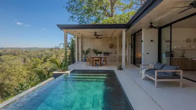 a swimming pool in the backyard of a house at Mahalo Villas in Playa hermosa