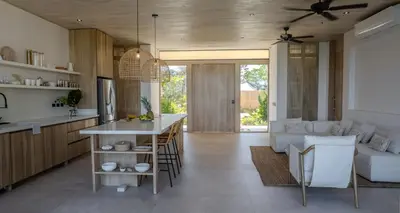 a kitchen and living room with a table and a couch at Mahalo Villas in Playa hermosa