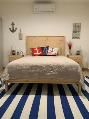 a bedroom with a bed with pillows on it at 2 Bedroom Oceanfront Condo with Wi-Fi, AC and Pool in Bejuco