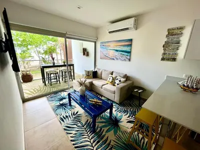 a living room with a couch and a table at 2 Bedroom Oceanfront Condo with Wi-Fi, AC and Pool in Bejuco