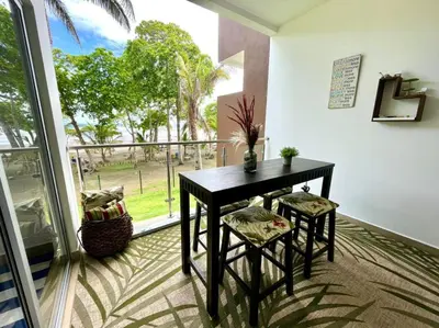 a room with a table and chairs and a balcony at 2 Bedroom Oceanfront Condo with Wi-Fi, AC and Pool in Bejuco