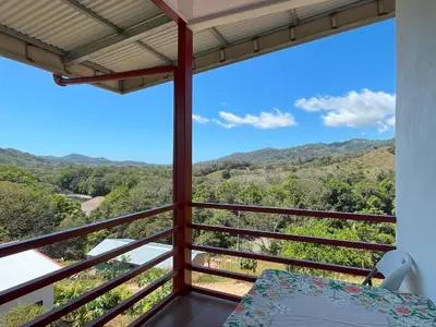 a balcony with a view of the mountains at Apartamentos Aquí Me Quedo in Nandayure