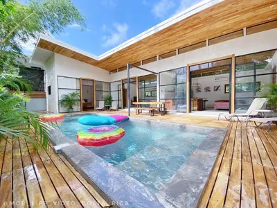 a swimming pool in the backyard of a house at Villa Primavera Santa Teresa Center- walking distance to the beach in Santa Teresa Beach