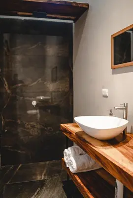 a bathroom with a white bowl sink on a wooden counter at Villa Primavera Santa Teresa Center- walking distance to the beach in Santa Teresa Beach