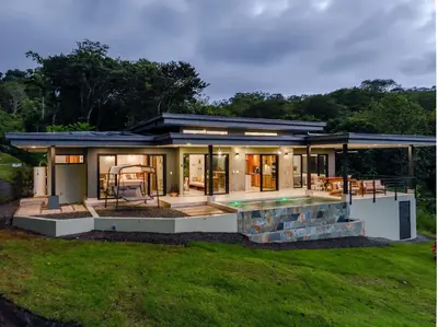 a house with a pool and a yard at New! Ocean View, Jungle Surrounded, Walk to Beach & River in Uvita