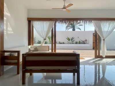 a bedroom with a bed and a ceiling fan at Casa Kairos CR, Playa Samara in Nicoya