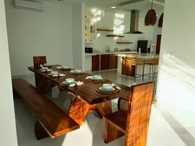 a dining room with a wooden table and chairs at Casa Kairos CR, Playa Samara in Nicoya