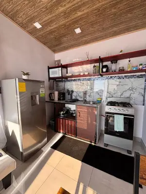 a kitchen with a stainless steel refrigerator and a stove at Cabina Hermanas Valencia in Monteverde Costa Rica