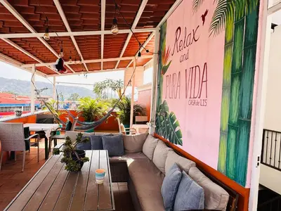 a patio with a couch and a table at Boutique Hotel Casa de Lis, Turrialba in Turrialba