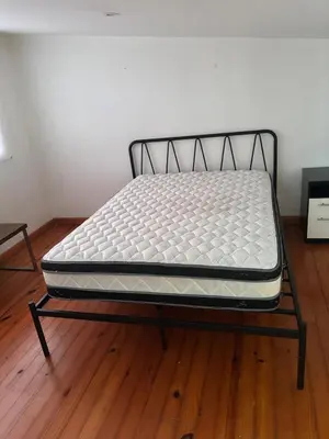 a bed sitting on a wooden floor in a room at Casa 8C Jaco Sol in Jacó