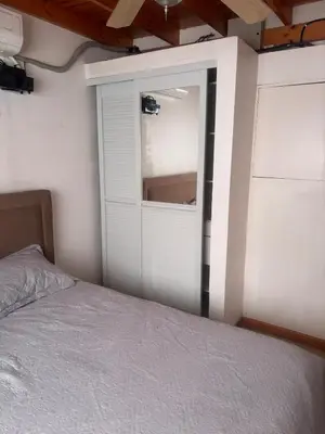 a bedroom with a bed and a sliding glass door at Casa 8C Jaco Sol in Jacó