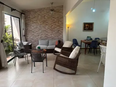 a living room with a couch and chairs and a table at Casa 8C Jaco Sol in Jacó