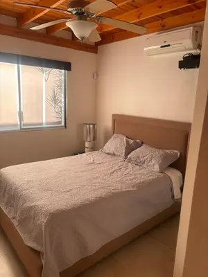 a bedroom with a bed and a ceiling fan at Casa 8C Jaco Sol in Jacó