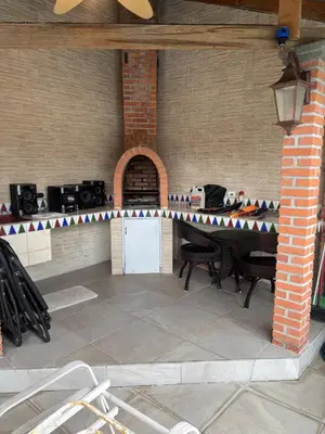 a patio with a table and chairs in a brick wall at Casa 8C Jaco Sol in Jacó