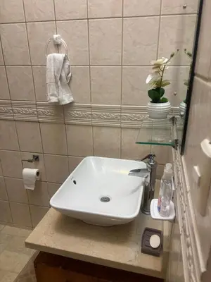 a bathroom with a white sink on a counter at Casa 8C Jaco Sol in Jacó