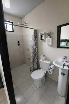 a bathroom with a toilet and a shower and a sink at Villa Jr 3, Piscina y Naturaleza, SJO Airport 80min in Tarcoles