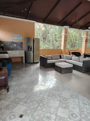 a large living room with a stainless steel refrigerator at Villa Jr 3, Piscina y Naturaleza, SJO Airport 80min in Tarcoles