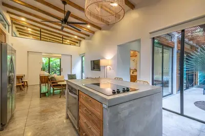 a kitchen with a large island in the middle of a room at Casita Pacífico Stunning Jungle Home in K-Section in Nicoya