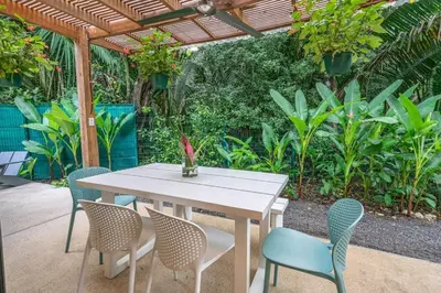 a white table and chairs under a pergola at Casita Pacífico Stunning Jungle Home in K-Section in Nicoya