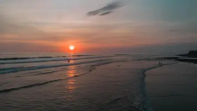 a sunset on a beach with the ocean at Dominical Long Term Rental in Savegre
