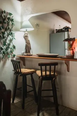 a kitchen with a counter with two bar stools at Dominical Long Term Rental in Savegre