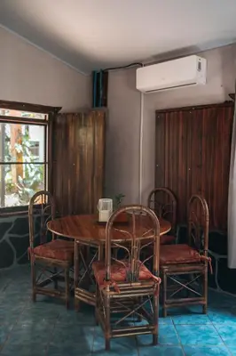 a dining room with a wooden table and chairs at Dominical Long Term Rental in Savegre