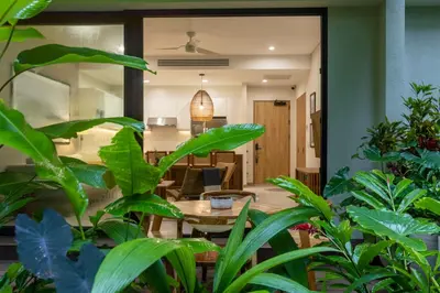 a room with a table and some plants at Pura Vida Peaceful Condo At Become Nosara in Nicoya