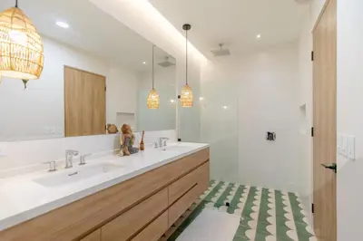 a bathroom with two sinks and a large mirror at Pura Vida Peaceful Condo At Become Nosara in Nicoya