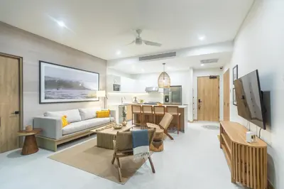a living room with a couch and a table at Pura Vida Peaceful Condo At Become Nosara in Nicoya