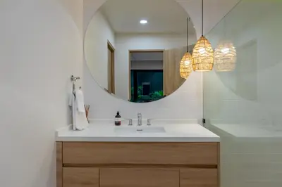 a bathroom with a sink and a mirror at Pura Vida Peaceful Condo At Become Nosara in Nicoya