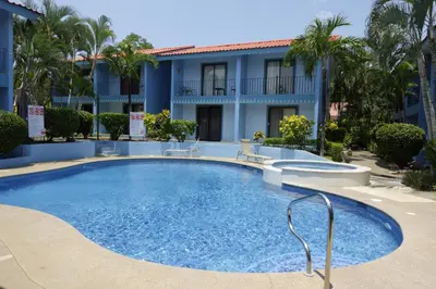 a swimming pool in front of a building at Pineapple Condo at Villa Riviera in Coco
