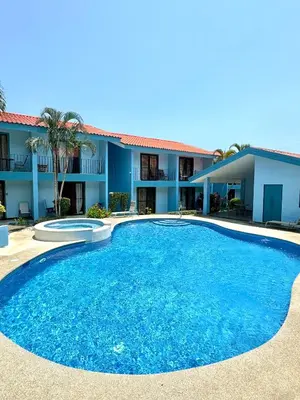 a large blue pool in front of a building at Pineapple Condo at Villa Riviera in Coco