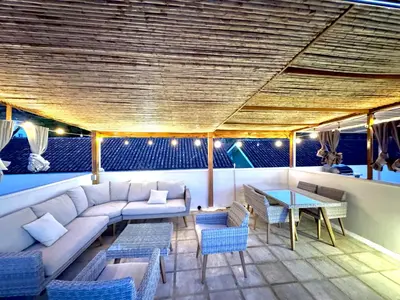 a living room with a couch and a table at Sunscape Second Floor Condo with Rooftop in Coco